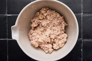 Hand mixed sausage ball mixture in a bowl