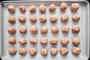 rolled sausage balls on a baking sheet before baking
