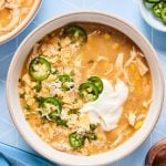 Crockpot White Chicken Chili in a bowl with fresh toppings and garnish