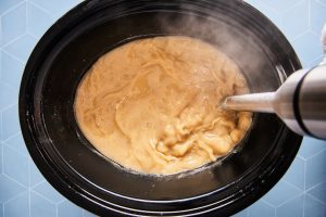 Immersion blender in the crockpot blending beans