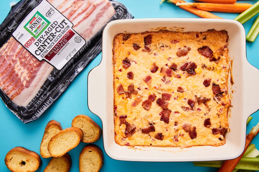 Baking dish of hot pimento dip with bacon package on the side