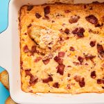 Baking dish of hot pimento cheese dip with bacon crumbled on t he top