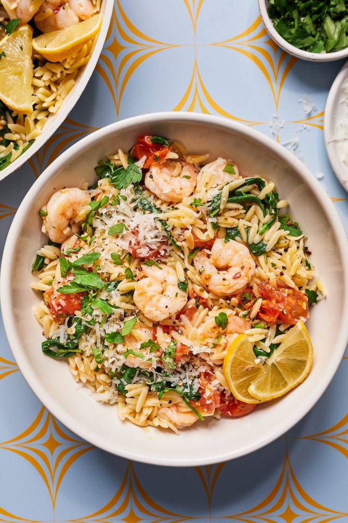 Bowl of orzo and shrimp with lemon and spinach
