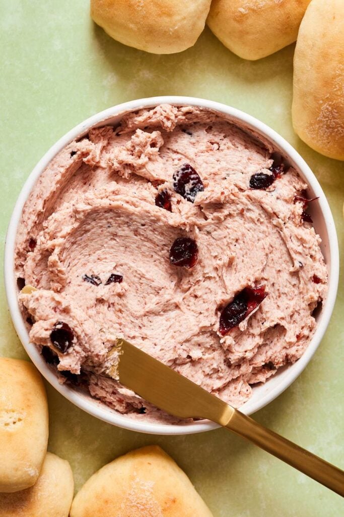 bowl of cranberry and honey butter with a knife
