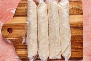 taco tortilla roll ups on a cutting board before slicing